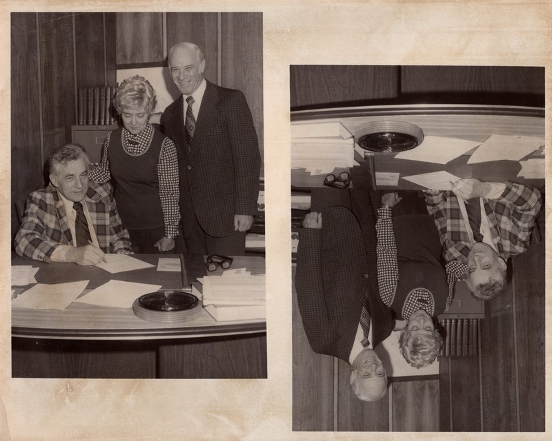 1 black and white photograph 3 individuals at a table signing a paper undated.jpg