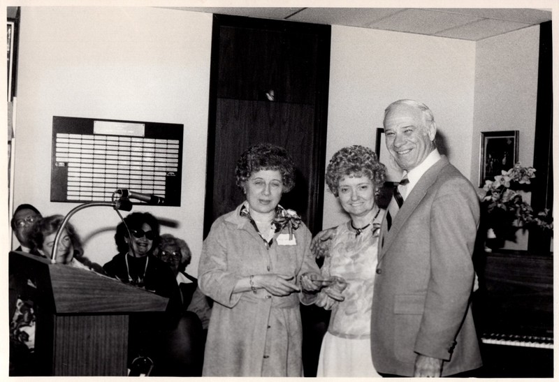 1 black and white photograph 3 people standing together at a podium undated.jpg