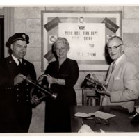 1 black and white photograph (8 x 10) one member of the fire department and two volunteers, undated