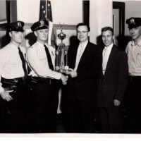 1 black and white photograph 8x10 safety patrol ward. pictured sgt. gavin blanc capt. edward jackob superintendent of Schools Donald C Jess and Officer Eugene Jackobsen 1955-56.jpg