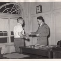 1 black and white photograph (8x10) Pierce Deamer presents award to member of Police Auxiliary undated.jpg