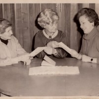 1 black and white photograph 3 women sitting at a table together talking undated.jpg