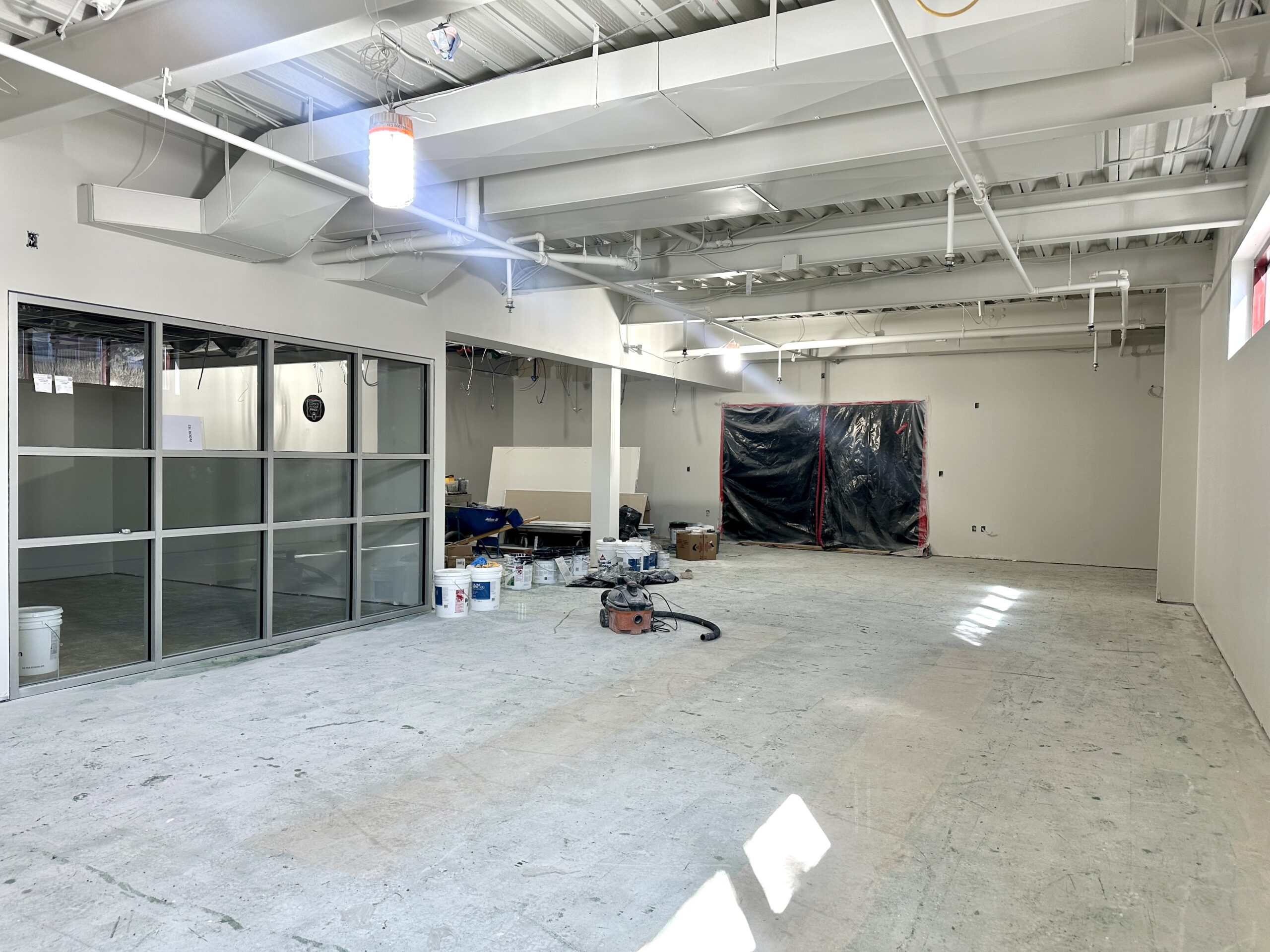 Image of new teen room construction from another angle. Walls have been put up and painted white.