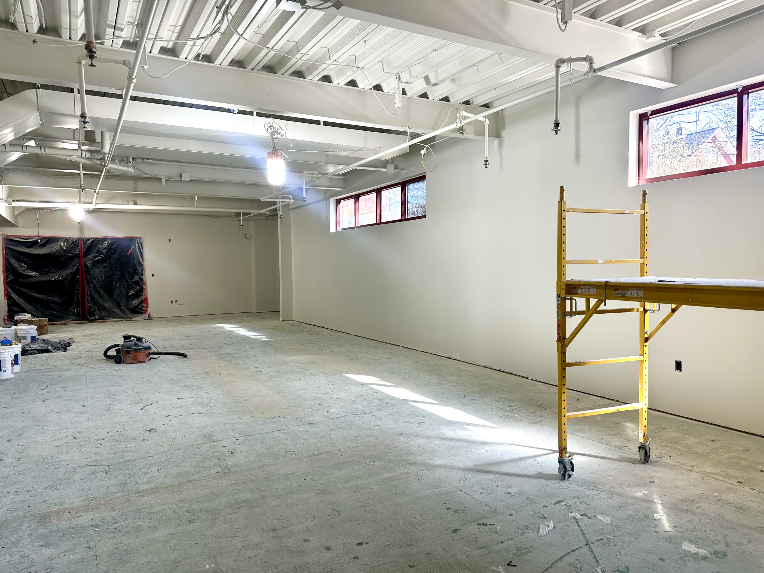 Image of new teen room construction from another angle. Walls have been put up and painted white.